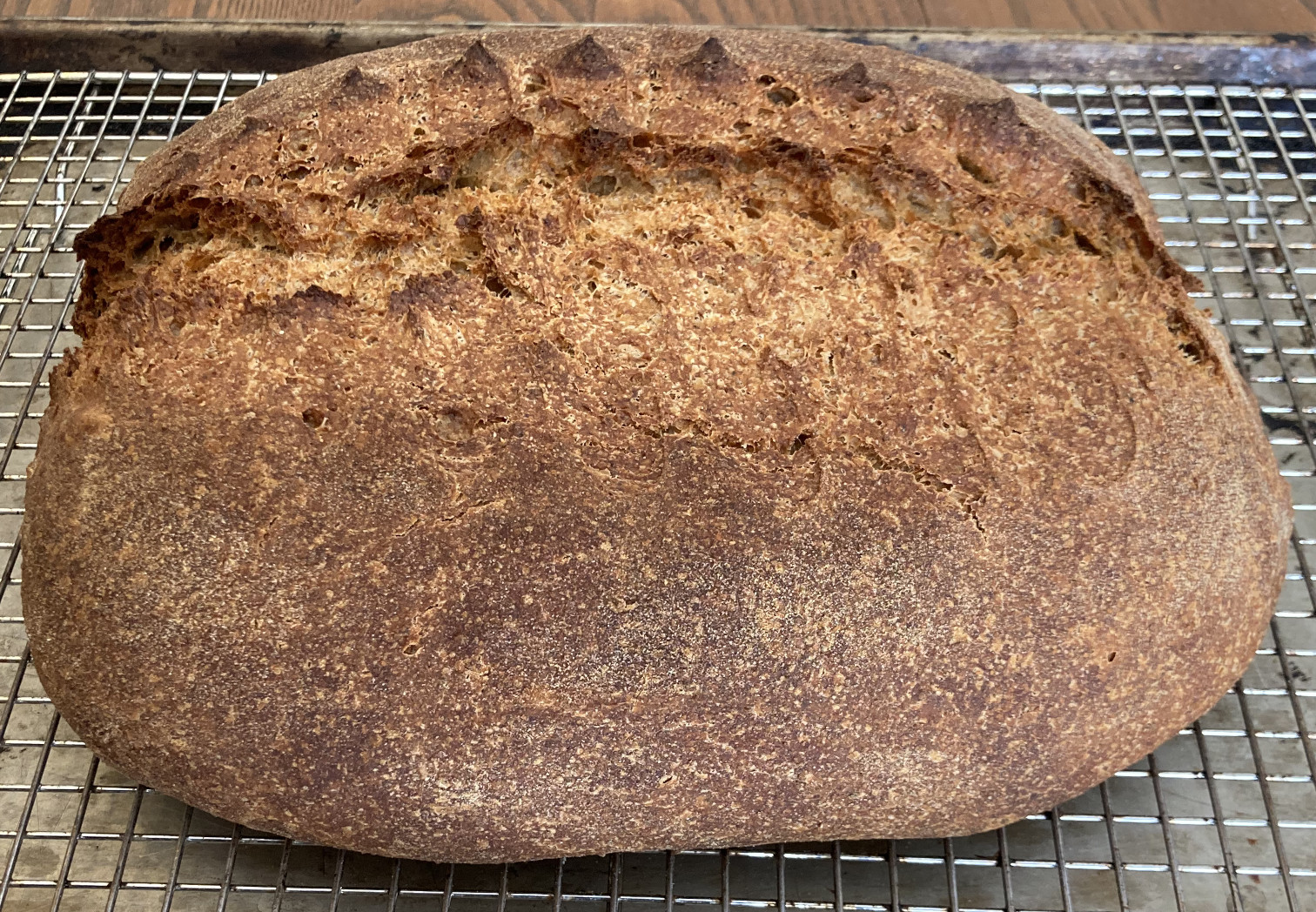 Loaf of bread on a cooling rack.