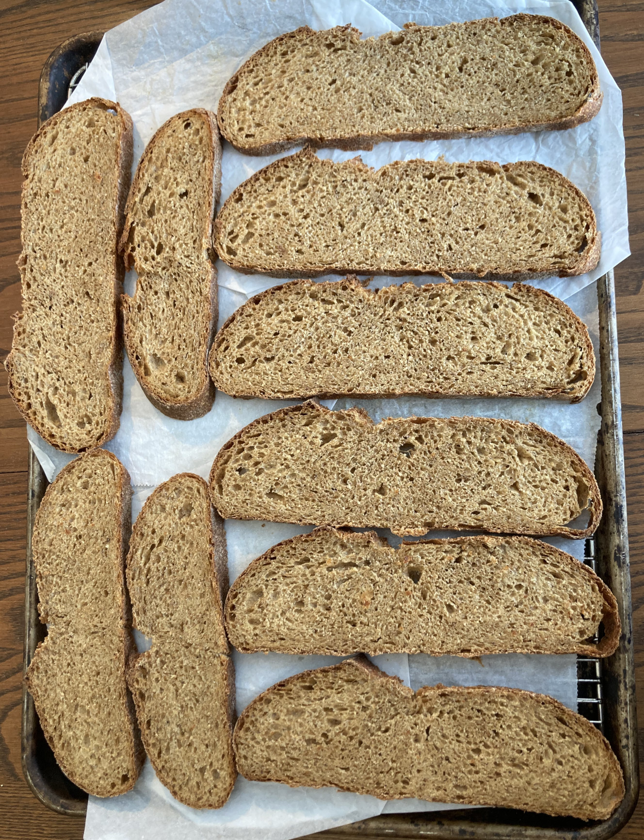 Ridiculously wide slices of bread on a parchment lined tray.