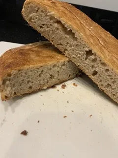 Sourdough loaf bisected, height of loaf approximately 1-2 inches